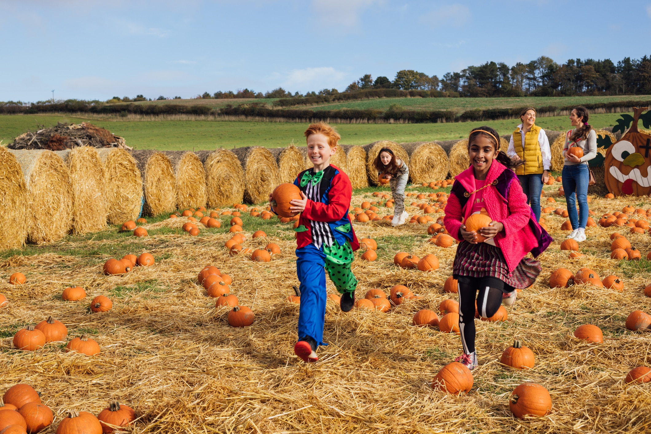 Kids collecting pumpkins